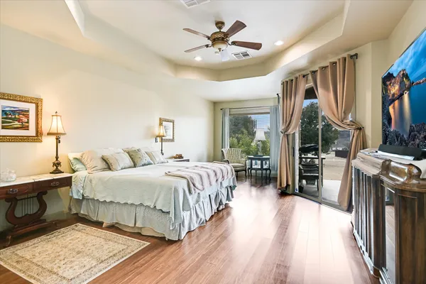 a bedroom with a bed and a chandelier
