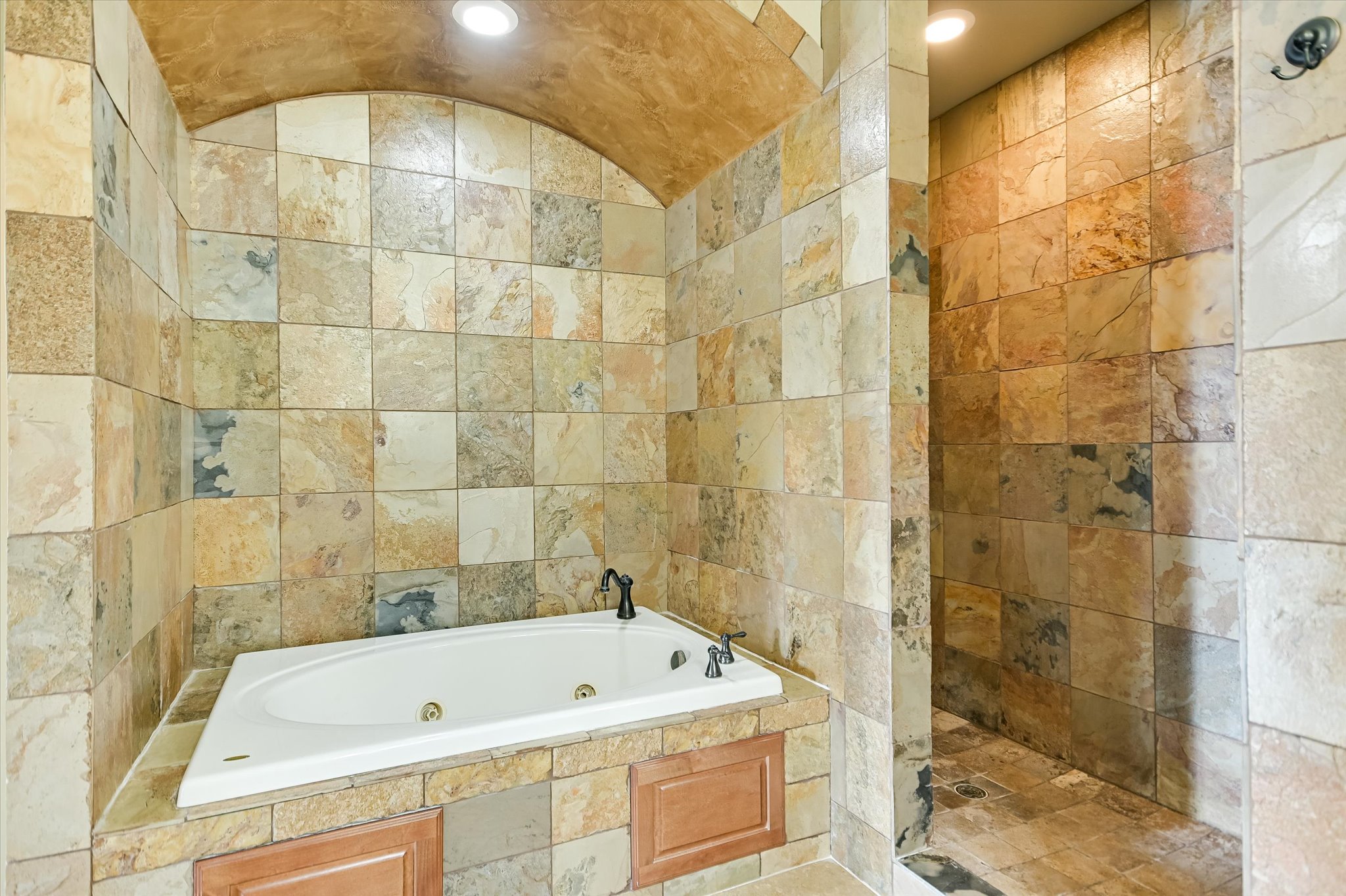 117 View Drive Georgetown, TX 78628 - Photo 20 of 40 Full bath featuring tile walls, a jetted tub, and walk in shower. Controls for shower at entrance away from rainshower head.