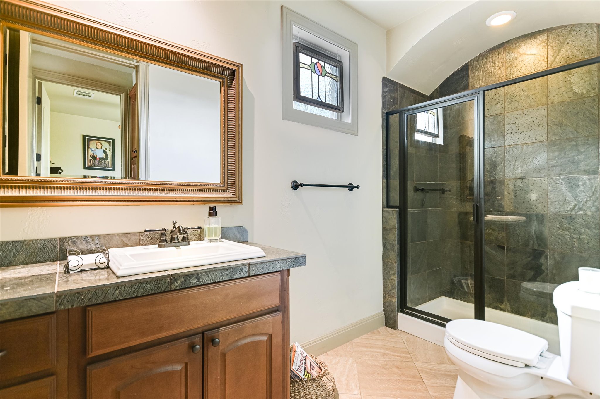 117 View Drive Georgetown, TX 78628 - Photo 22 of 40 Bathroom with vanity and stone counter, a tiled shower stall, and light tile patterned floors. Stained glass window conveys.