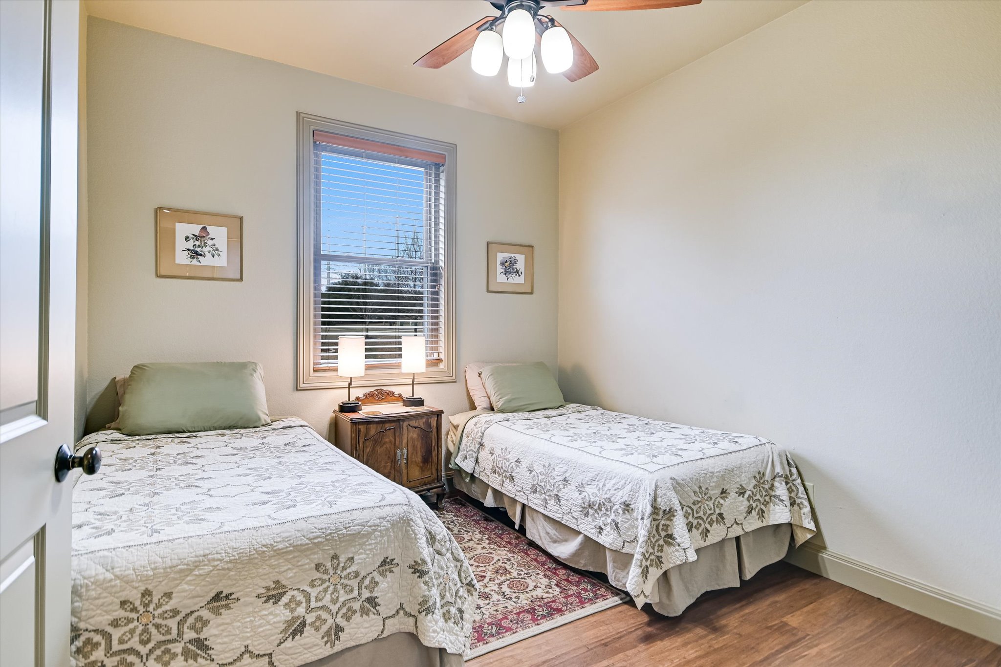 117 View Drive Georgetown, TX 78628 - Photo 25 of 40 Bedroom with ceiling fan and wood finished floors, and double hung window.