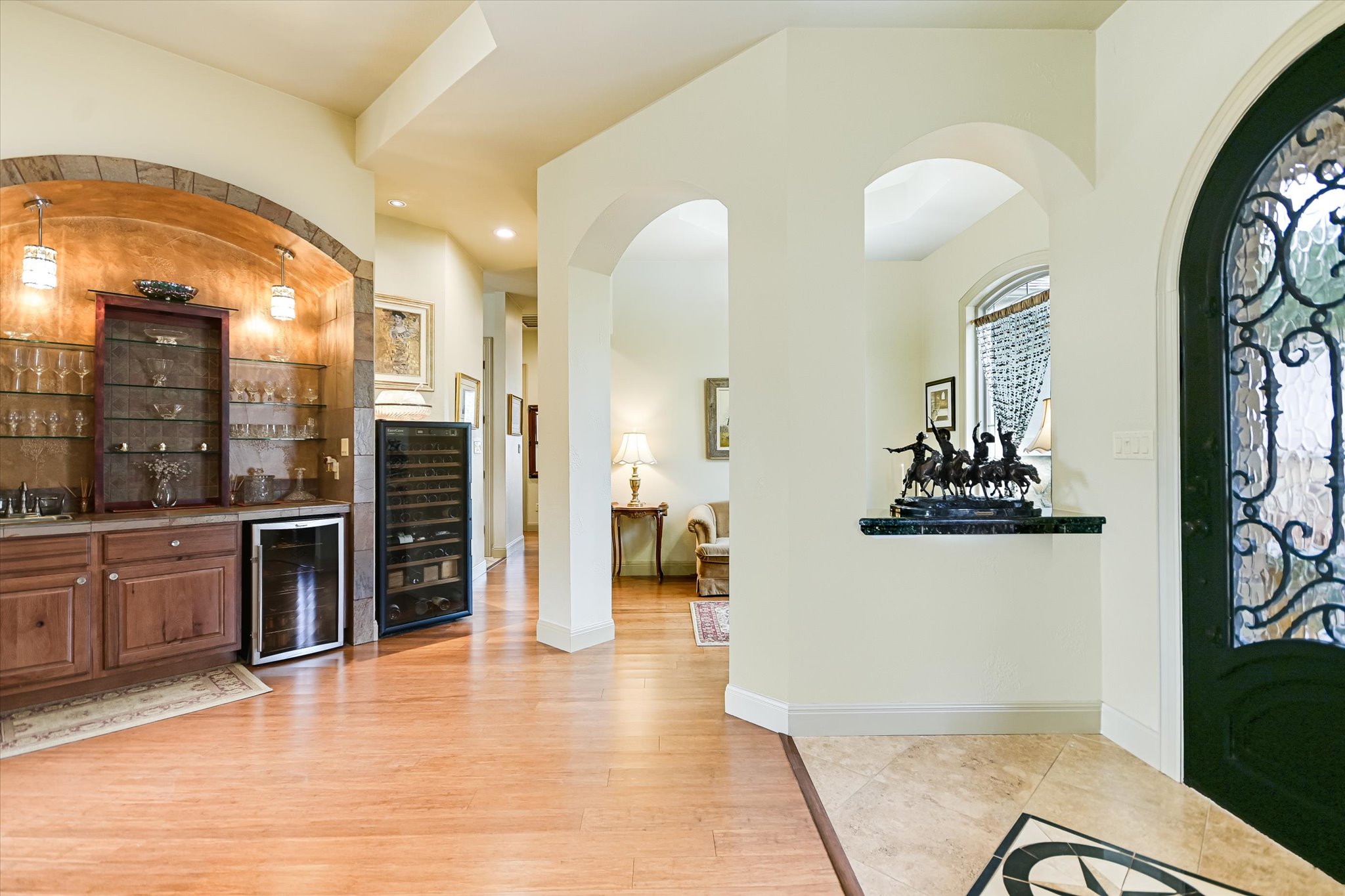 117 View Drive Georgetown, TX 78628 - Photo 9 of 40 Foyer featuring a bar, beverage cooler, arched walkways, light wood flooring, and recessed lighting
