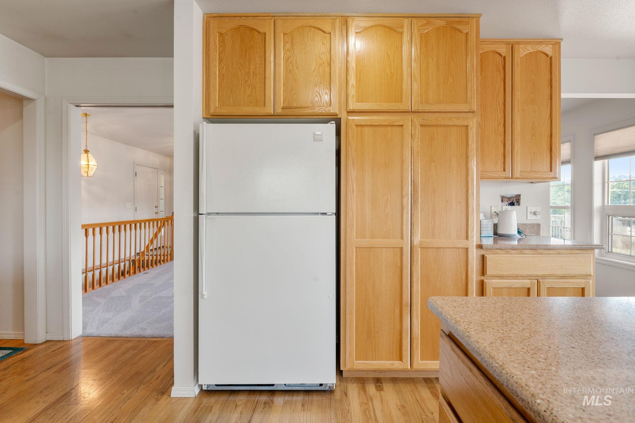 824 15th Avenue Lewiston, ID 83501 - Photo 12 of 37 Kitchen with freestanding refrigerator, light wood-type flooring, light brown cabinetry, and light stone counters