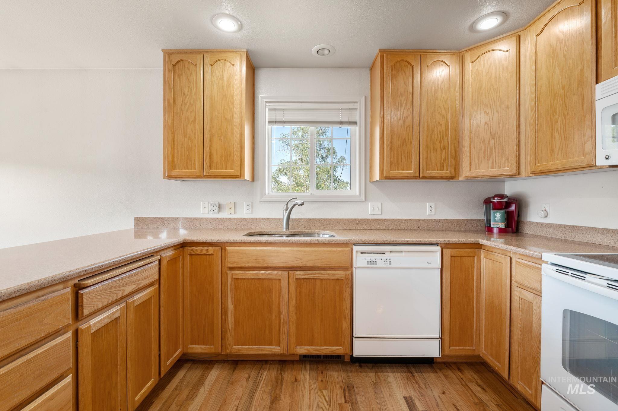 824 15th Avenue Lewiston, ID 83501 - Photo 13 of 37 Kitchen featuring white appliances, light countertops, light wood-style floors, light brown cabinets, and recessed lighting