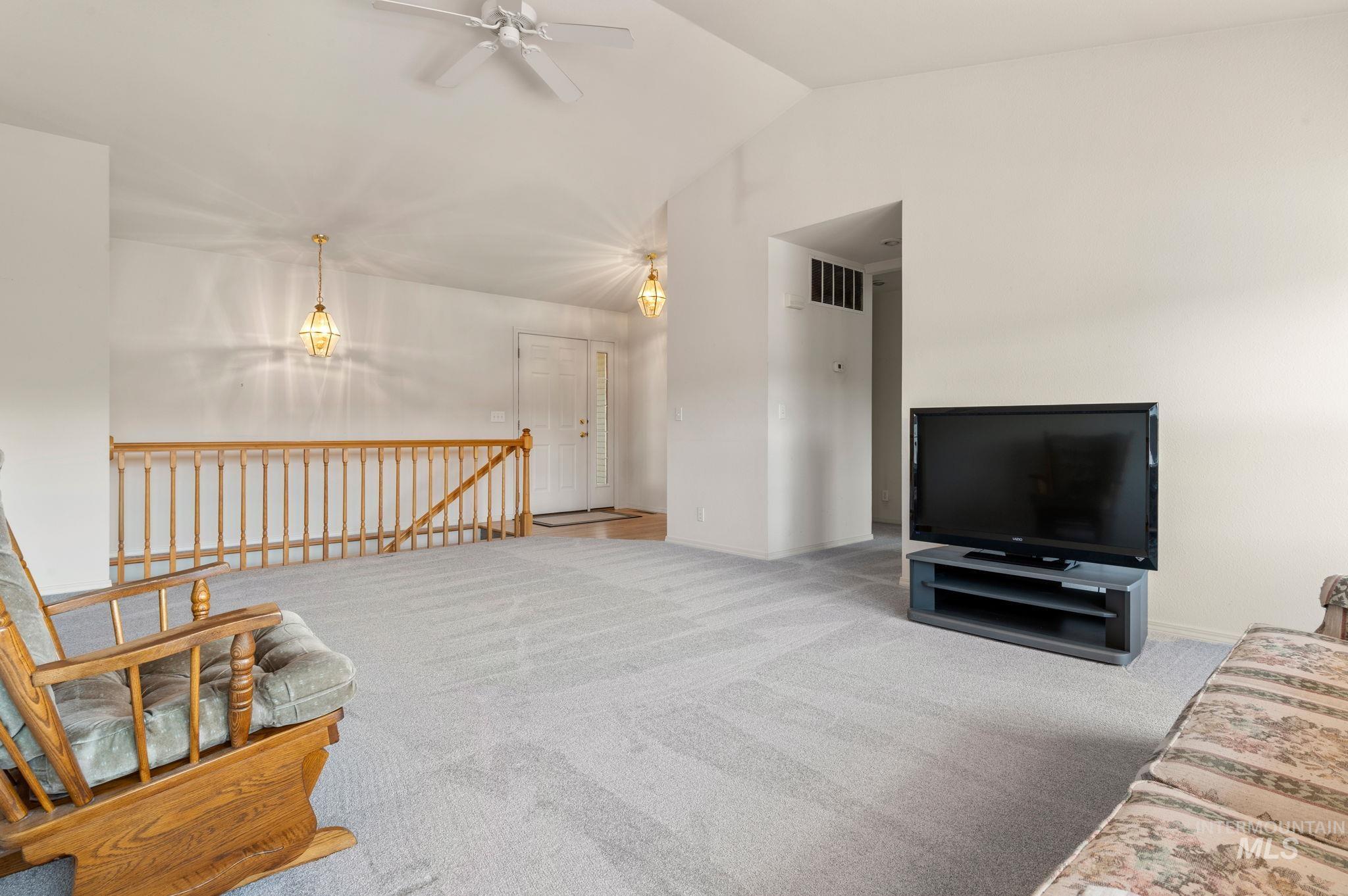 824 15th Avenue Lewiston, ID 83501 - Photo 4 of 37 Carpeted living room featuring ceiling fan and vaulted ceiling