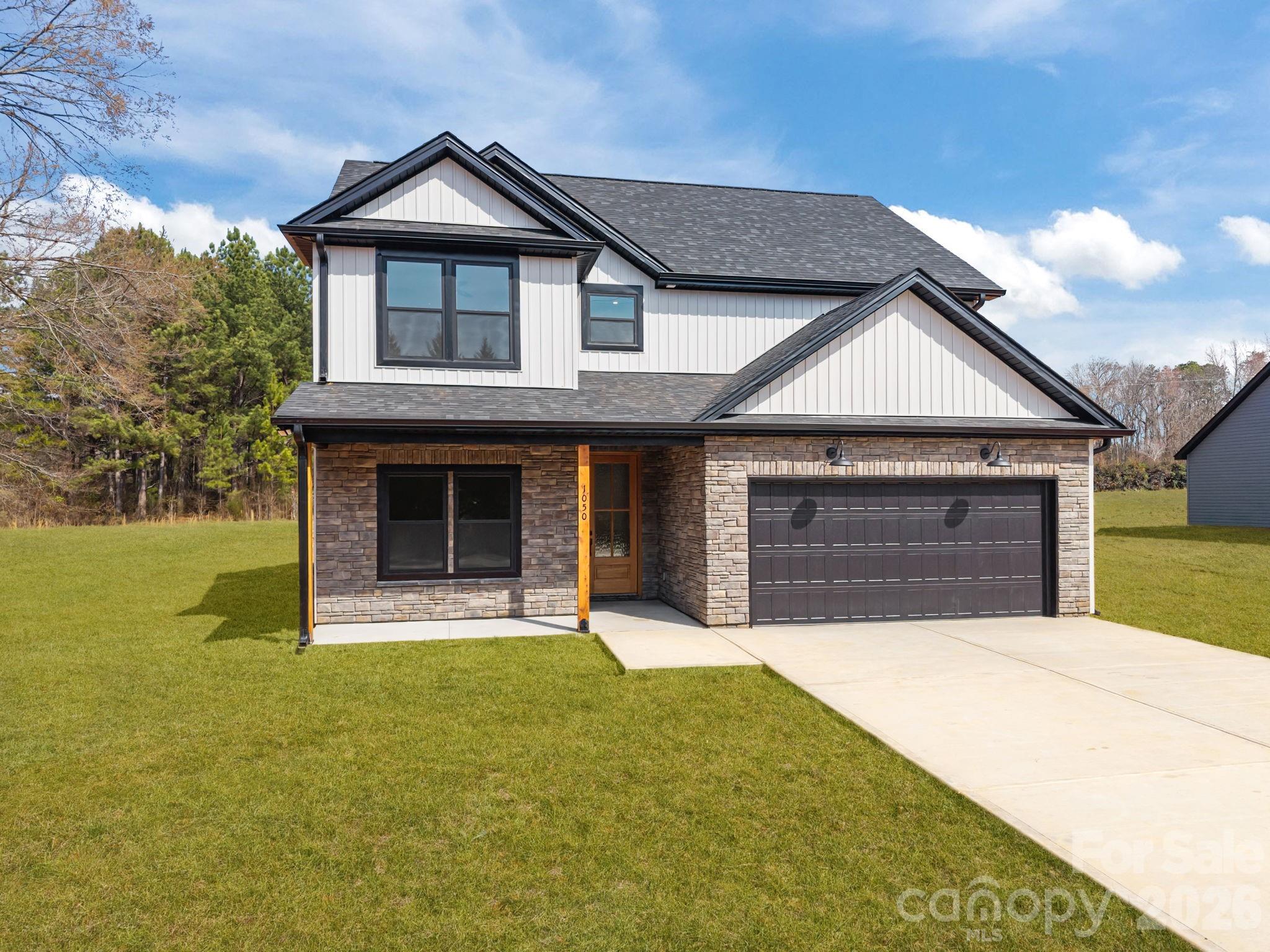 1050 Gibson Road Salisbury, NC 28147 - Photo 1 of 47 a front view of a house with a yard and garage