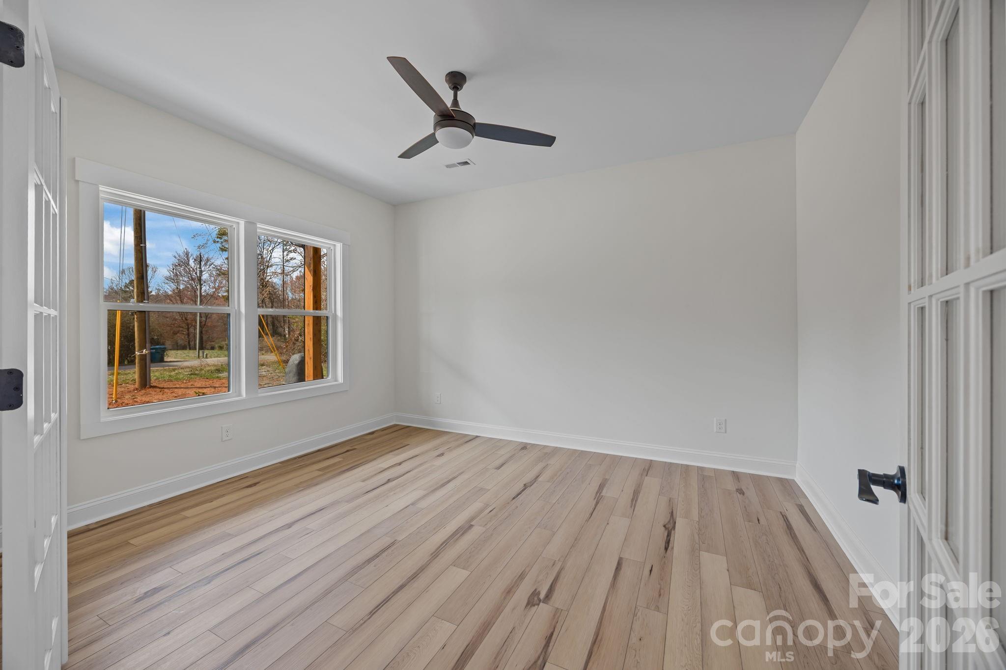 1050 Gibson Road Salisbury, NC 28147 - Photo 12 of 47 a view of empty room with wooden floor and fan