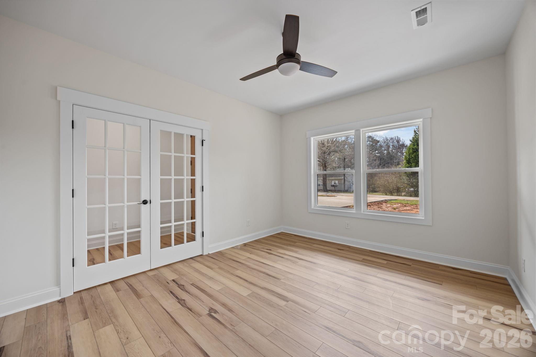 1050 Gibson Road Salisbury, NC 28147 - Photo 13 of 47 a view of an empty room with a window and wooden floor