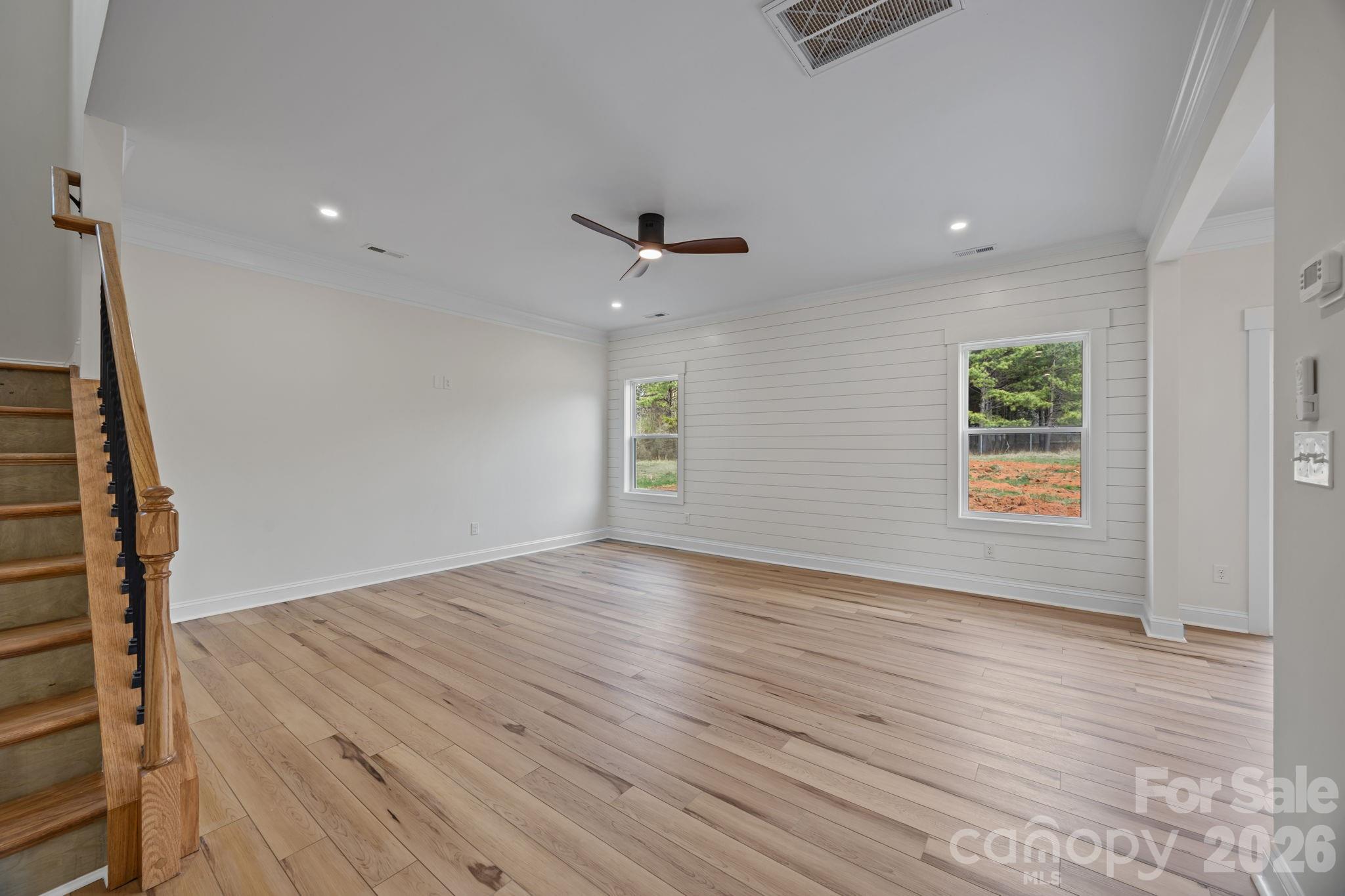 1050 Gibson Road Salisbury, NC 28147 - Photo 14 of 47 an empty room with wooden floor and a ceiling fan