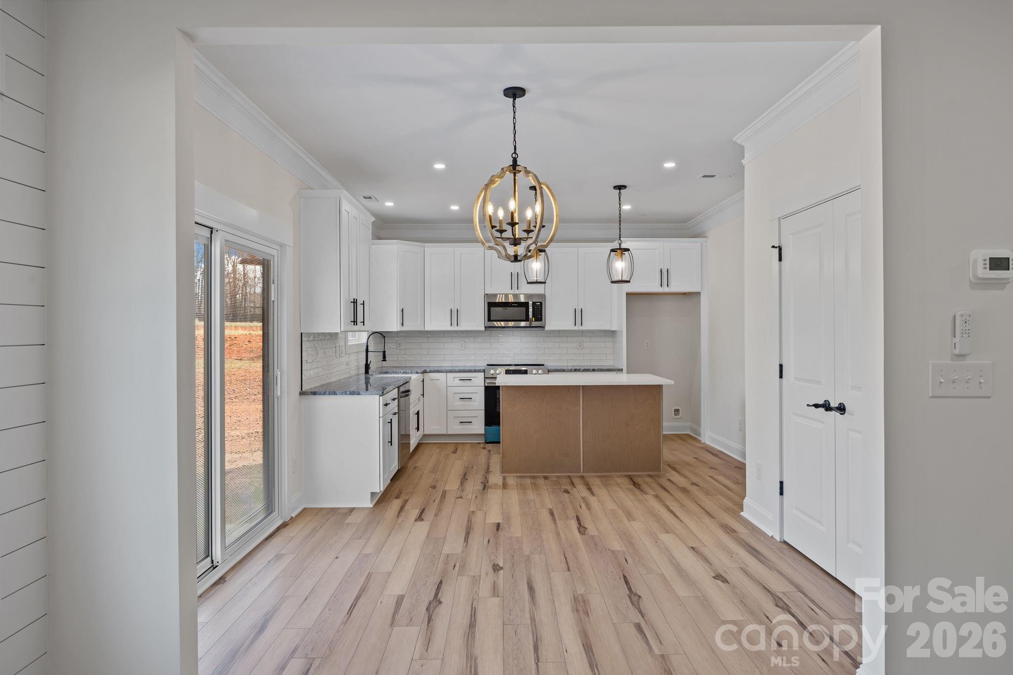 1050 Gibson Road Salisbury, NC 28147 - Photo 18 of 47 a large kitchen with stainless steel appliances granite countertop a lot of counter space and wooden floor