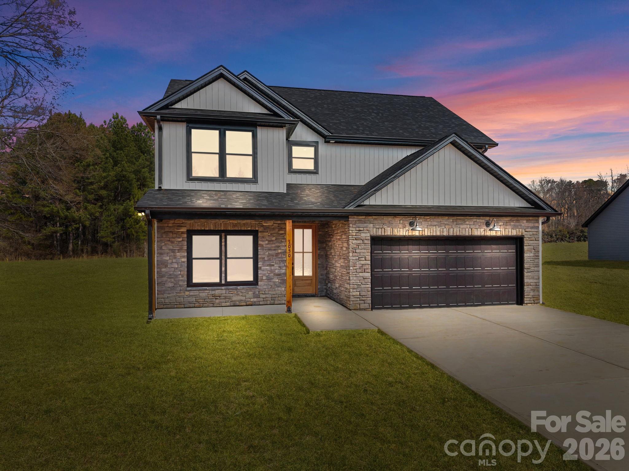 1050 Gibson Road Salisbury, NC 28147 - Photo 2 of 47 a front view of a house with a yard and garage