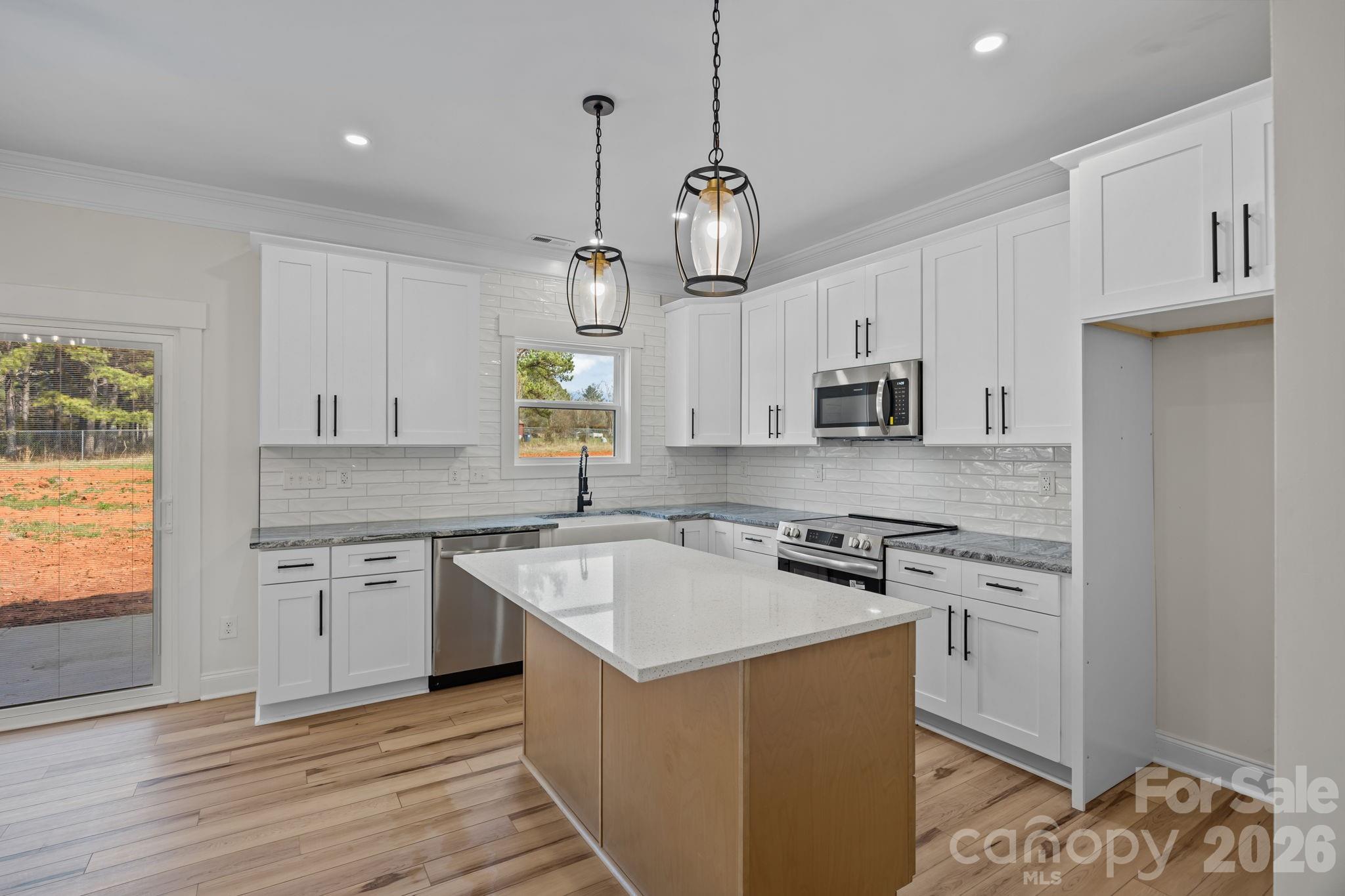 1050 Gibson Road Salisbury, NC 28147 - Photo 22 of 47 a kitchen with stainless steel appliances granite countertop a sink stove and refrigerator