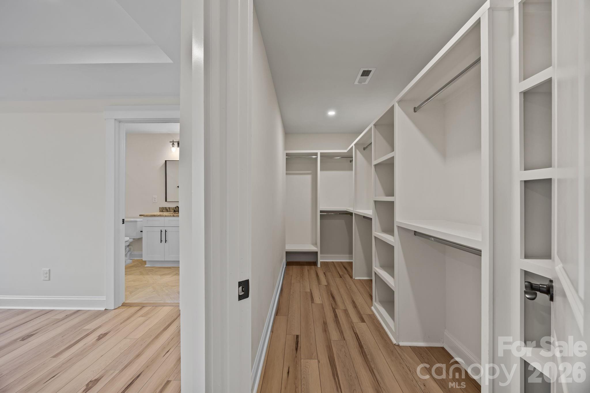 1050 Gibson Road Salisbury, NC 28147 - Photo 30 of 47 a view of walk in closet with wooden floor and a bathroom