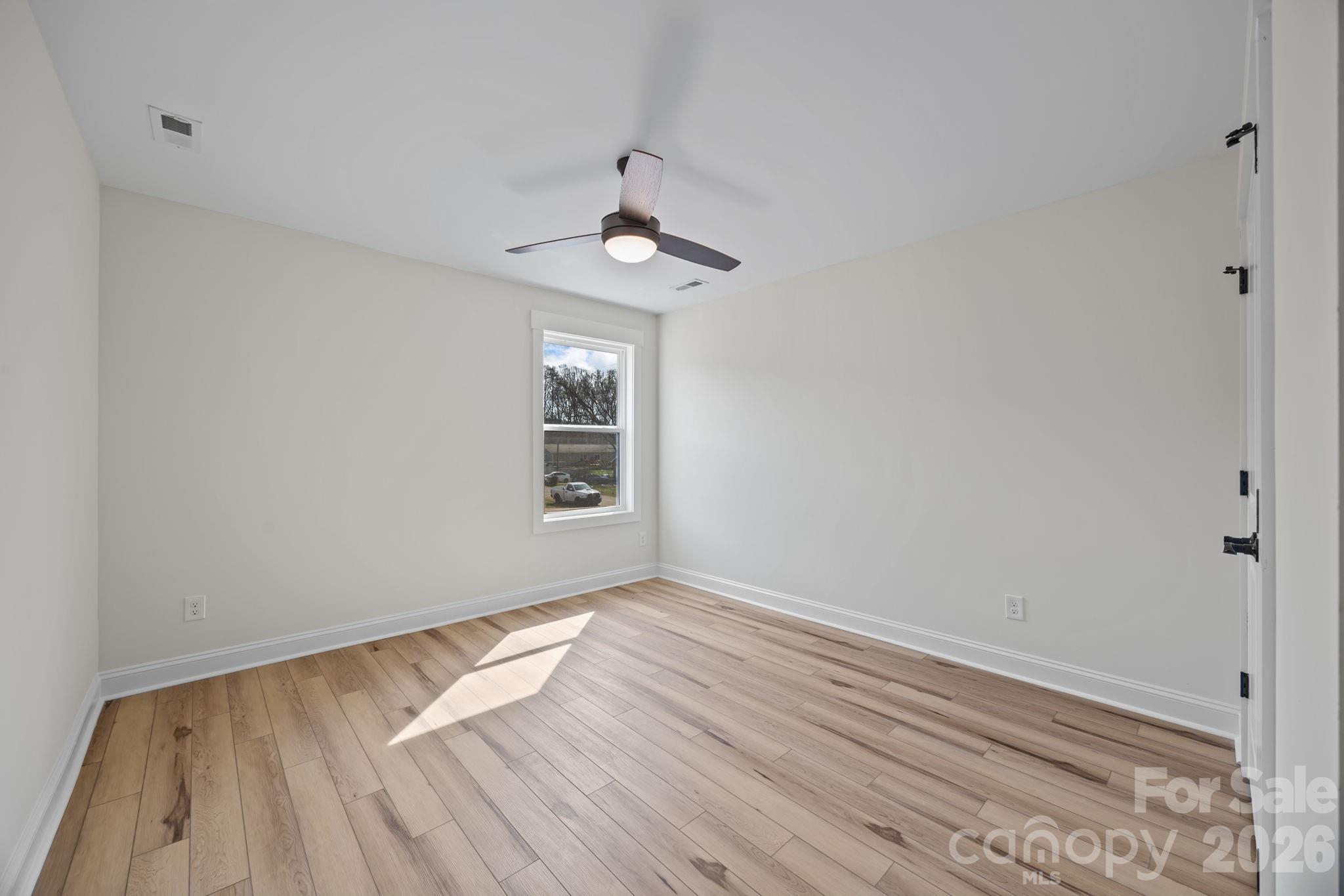 1050 Gibson Road Salisbury, NC 28147 - Photo 37 of 47 wooden floor in an empty room with a window