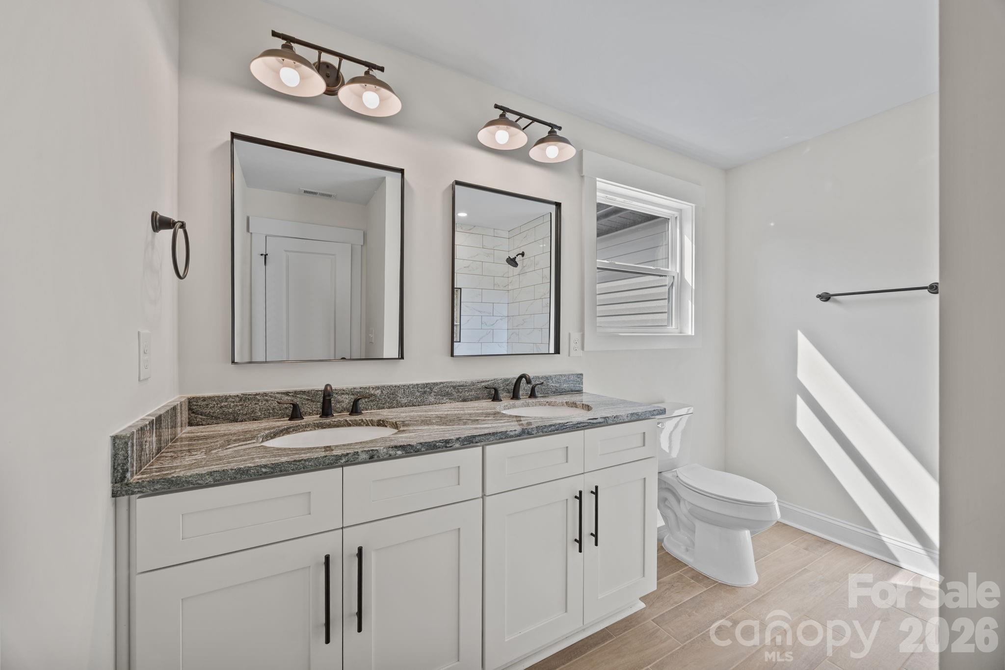 1050 Gibson Road Salisbury, NC 28147 - Photo 40 of 47 a bathroom with a toilet sink and mirror