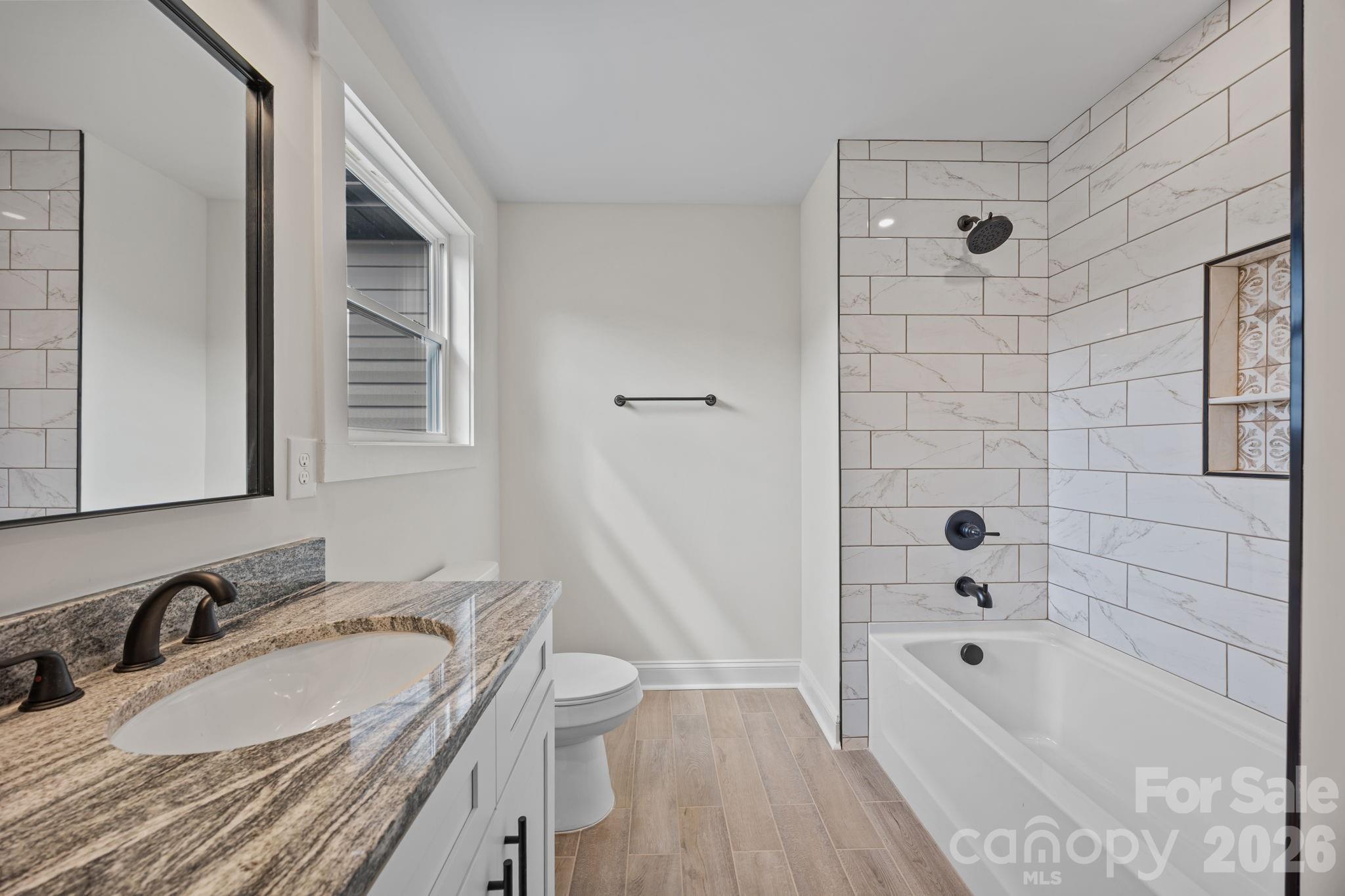 1050 Gibson Road Salisbury, NC 28147 - Photo 41 of 47 a bathroom with a granite countertop tub sink toilet and shower