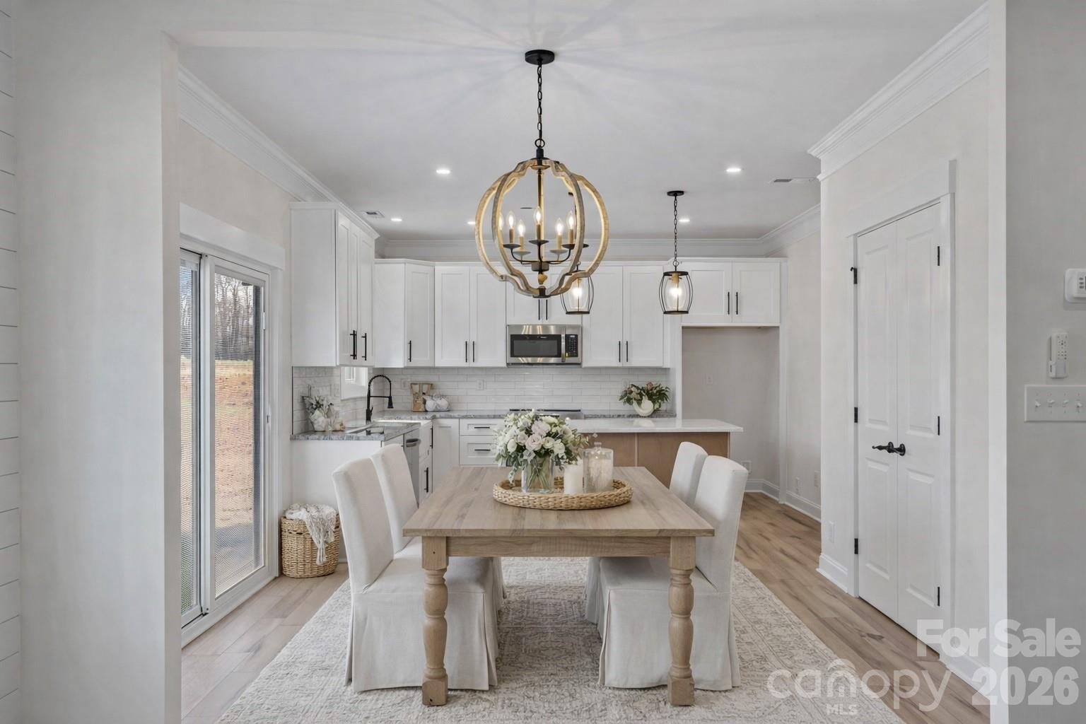 1050 Gibson Road Salisbury, NC 28147 - Photo 5 of 47 a view of a dining room with furniture a chandelier and wooden floor