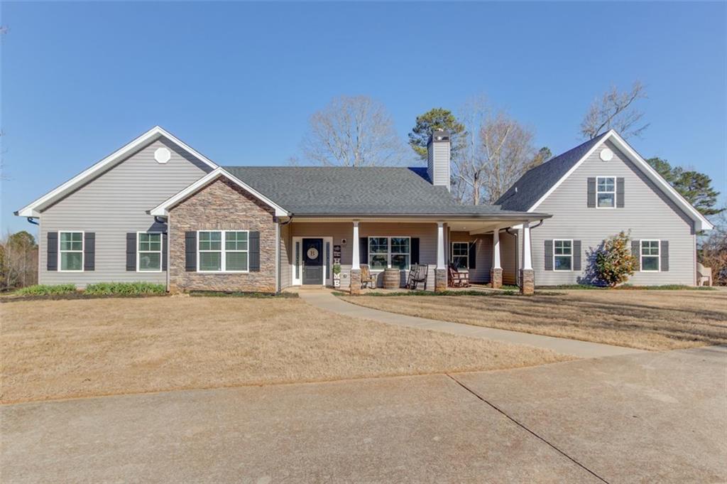 4404 Tanners Mill Road Braselton, GA 30517 - Photo 22 of 76 a front view of a house with a yard and garage