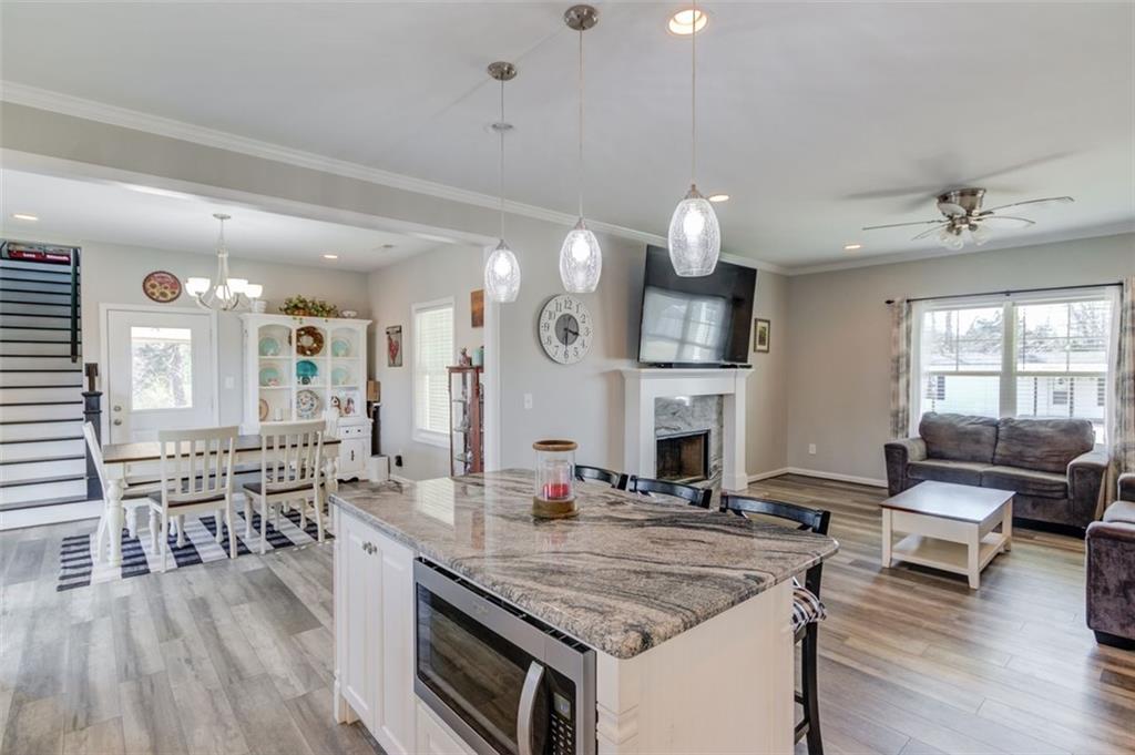 4404 Tanners Mill Road Braselton, GA 30517 - Photo 29 of 76 a kitchen with center island dining table and chairs