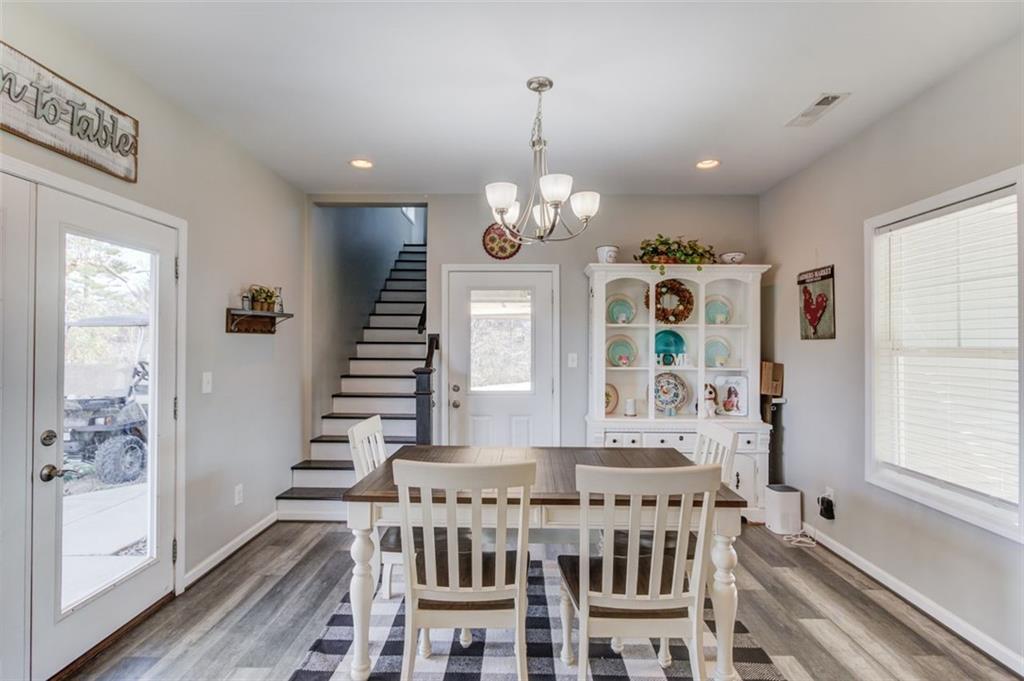4404 Tanners Mill Road Braselton, GA 30517 - Photo 30 of 76 a view of a dining room with furniture wooden floor and chandelier