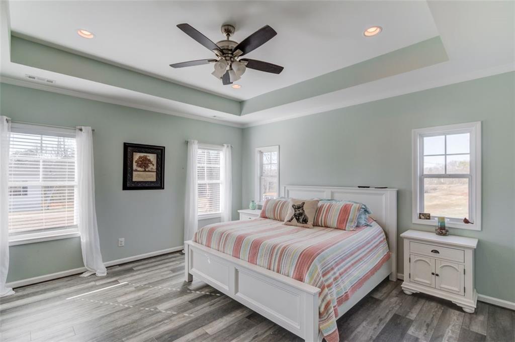 4404 Tanners Mill Road Braselton, GA 30517 - Photo 32 of 76 a bedroom with a large bed and a window