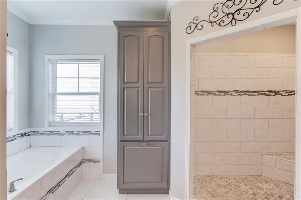 4404 Tanners Mill Road Braselton, GA 30517 - Photo 34 of 76 a bathroom with a bathtub and a shower