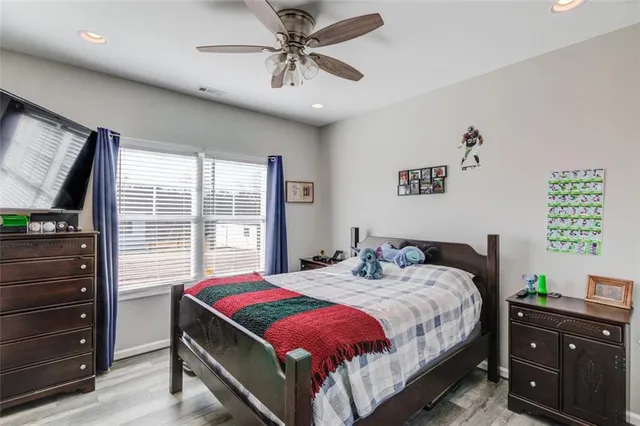 a living room with furniture a flat screen tv and a large window