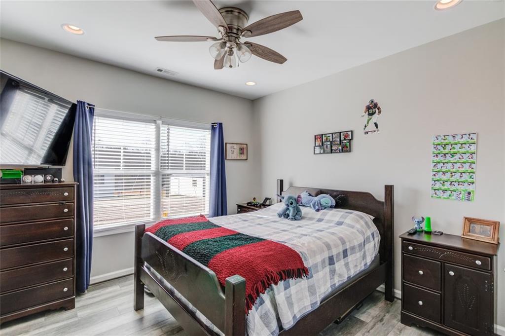 4404 Tanners Mill Road Braselton, GA 30517 - Photo 36 of 76 a bedroom with a bed and a flat screen tv