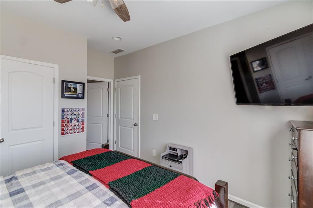 4404 Tanners Mill Road Braselton, GA 30517 - Photo 37 of 76 a bedroom with a bed and a view of bathroom