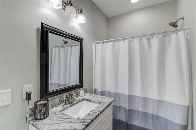 a kitchen with granite countertop a stove top oven sink and cabinets