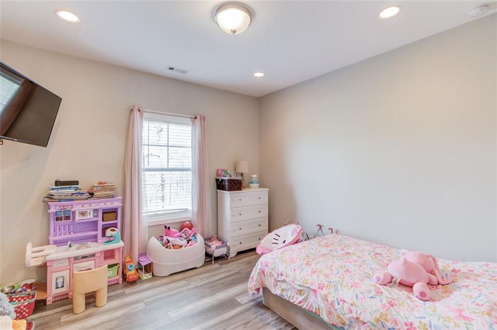 4404 Tanners Mill Road Braselton, GA 30517 - Photo 39 of 76 a bedroom with a bed and a window