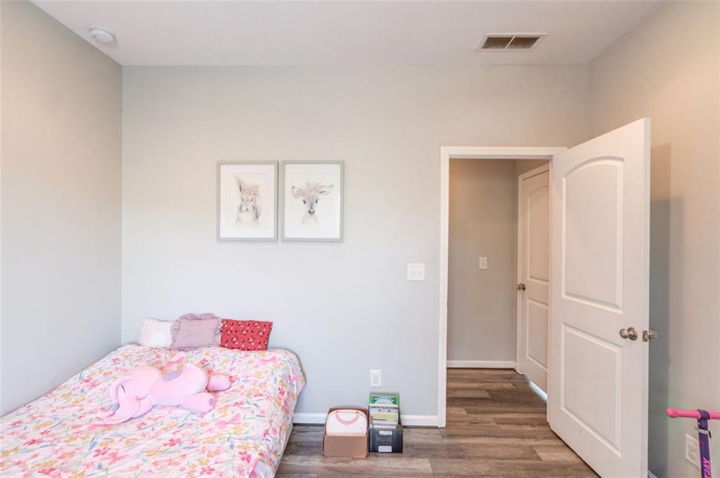 4404 Tanners Mill Road Braselton, GA 30517 - Photo 40 of 76 a bedroom with a bed and a view of bathroom