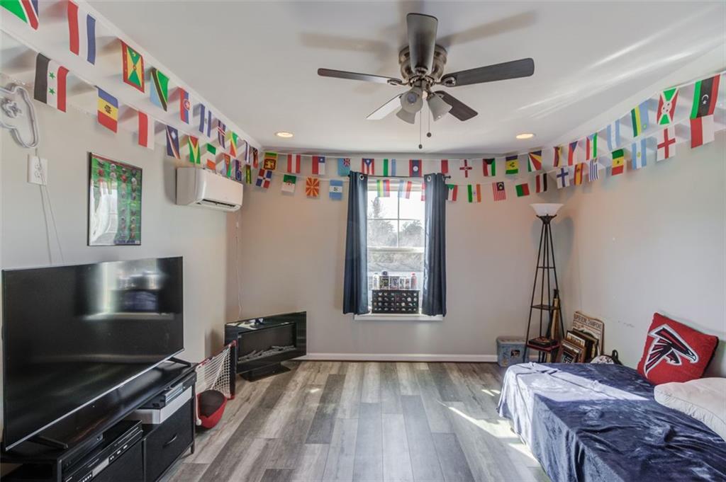 4404 Tanners Mill Road Braselton, GA 30517 - Photo 43 of 76 a living room with furniture flat screen tv and a window