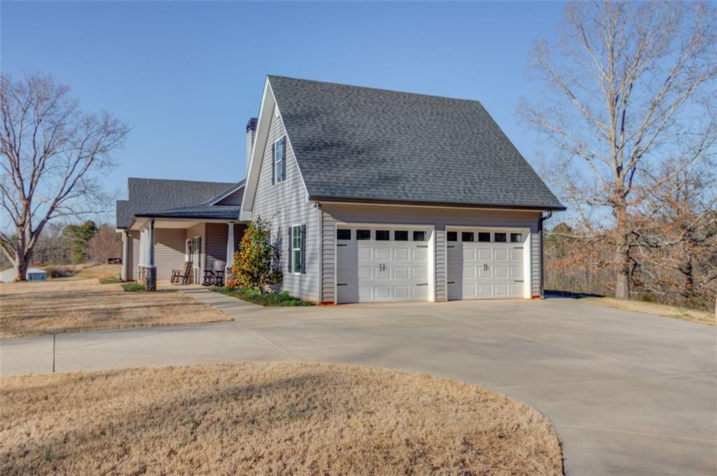4404 Tanners Mill Road Braselton, GA 30517 - Photo 46 of 76 a front view of a house with a yard and garage