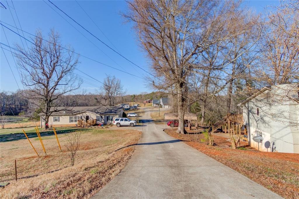 4404 Tanners Mill Road Braselton, GA 30517 - Photo 51 of 76 a view of road with card and trees