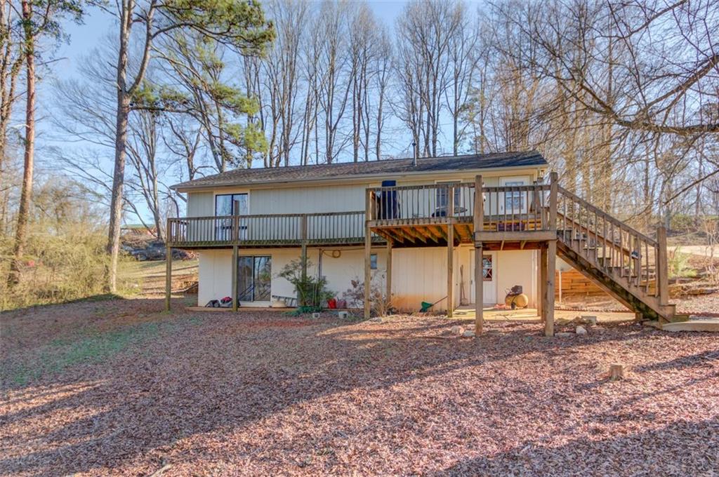 4404 Tanners Mill Road Braselton, GA 30517 - Photo 54 of 76 a view of a house with a yard and sitting area