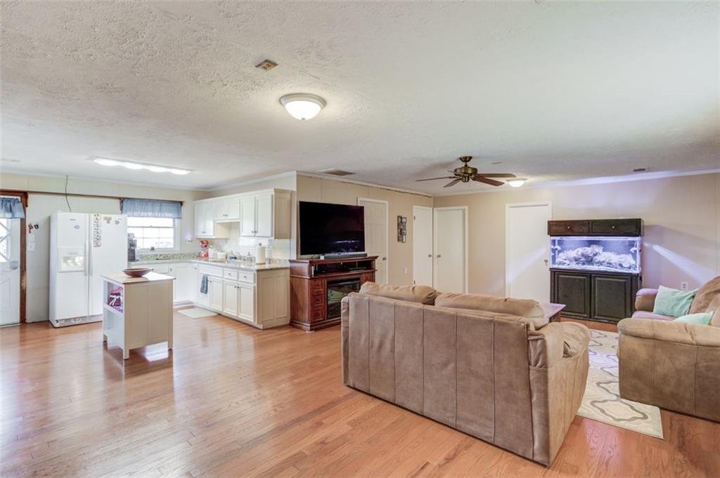 4404 Tanners Mill Road Braselton, GA 30517 - Photo 61 of 76 a living room with furniture and a flat screen tv
