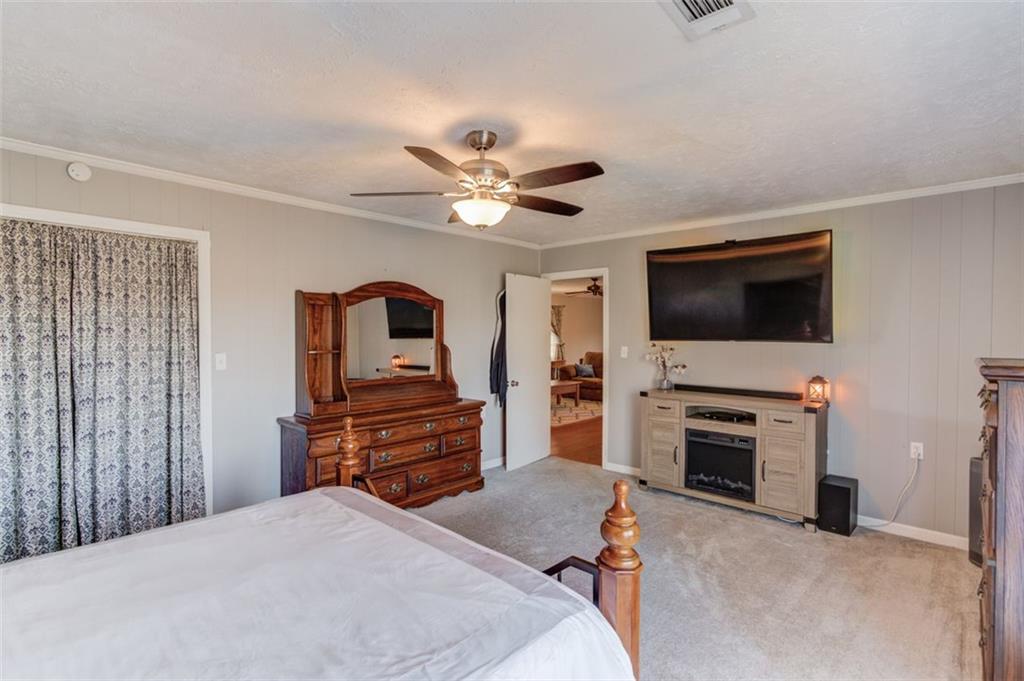 4404 Tanners Mill Road Braselton, GA 30517 - Photo 63 of 76 a bedroom with furniture and flat screen tv