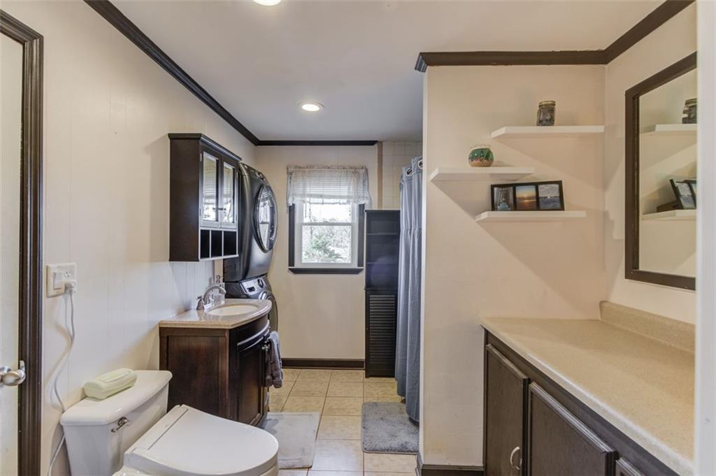 4404 Tanners Mill Road Braselton, GA 30517 - Photo 64 of 76 a bathroom with a toilet sink and mirror