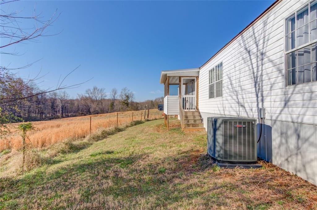 4404 Tanners Mill Road Braselton, GA 30517 - Photo 73 of 76 a view of backyard with large tree and wooden fence