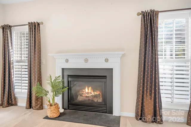 a living room with a fireplace and a large window