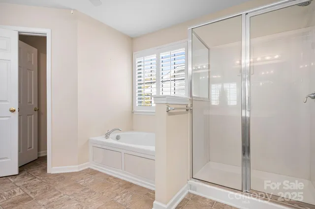 a bathroom with a shower a sink and a mirror