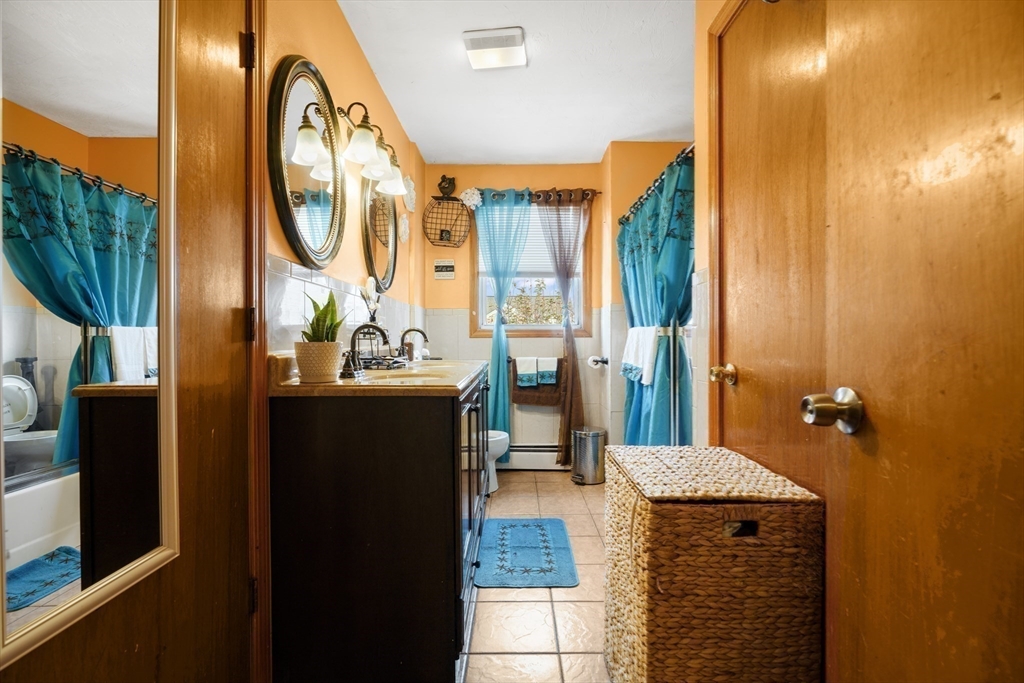 76 Price Place Fall River, MA 02724 - Photo 11 of 27 a bathroom with a granite countertop sink and a mirror