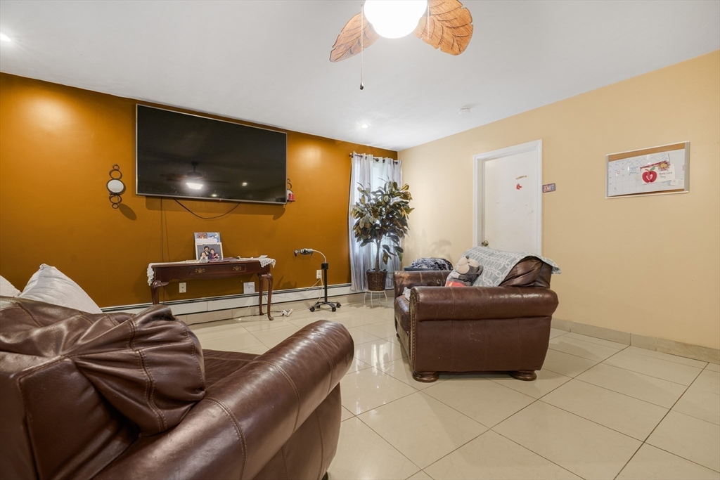 76 Price Place Fall River, MA 02724 - Photo 12 of 27 a living room with furniture and a flat screen tv