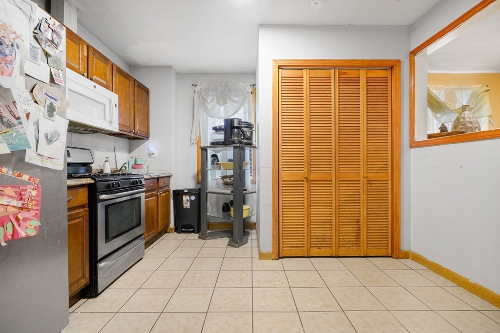 76 Price Place Fall River, MA 02724 - Photo 17 of 27 a kitchen with stainless steel appliances granite countertop a refrigerator and a stove