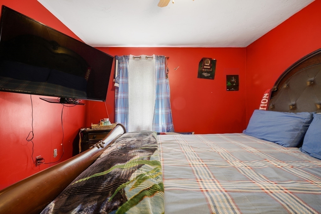 76 Price Place Fall River, MA 02724 - Photo 18 of 27 a bedroom with a bed and wooden floor