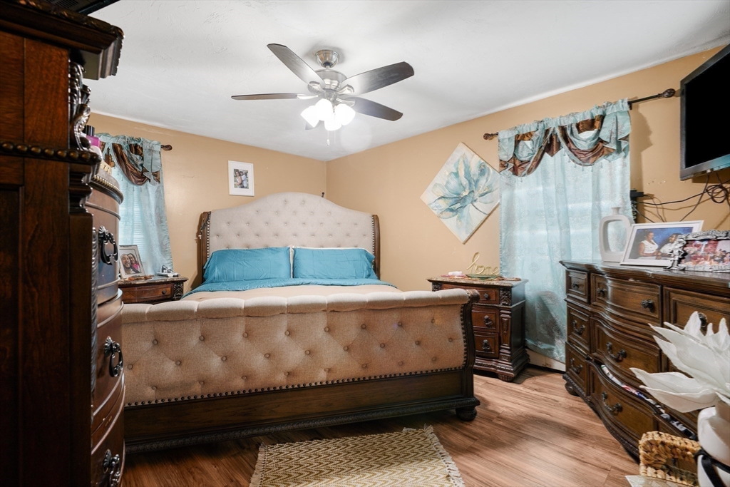 76 Price Place Fall River, MA 02724 - Photo 21 of 27 a bedroom with a bed and a flat tv screen on the dresser