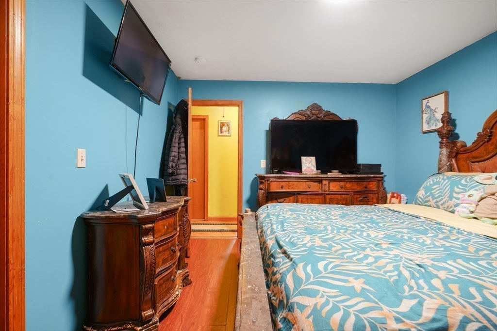 76 Price Place Fall River, MA 02724 - Photo 22 of 27 a bedroom with a bed and a flat screen tv