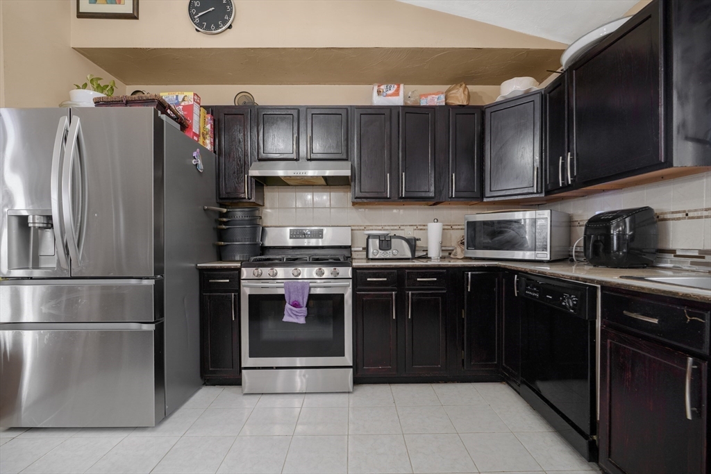 76 Price Place Fall River, MA 02724 - Photo 9 of 27 a kitchen with stainless steel appliances granite countertop a refrigerator and a sink