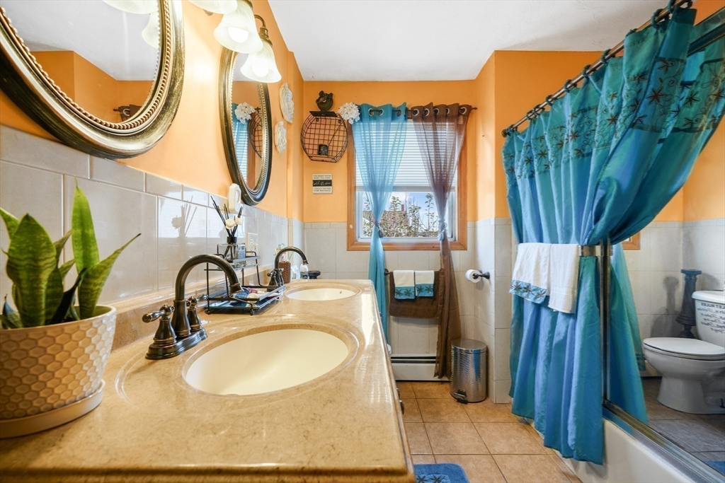 76 Price Place Fall River, MA 02724 - Photo 10 of 27 a bathroom with a sink a mirror and a shower
