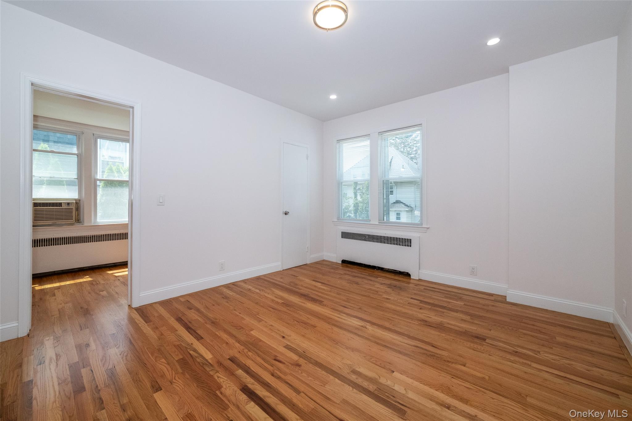 7 Alpha Place, Unit FIRST New Rochelle, NY 10805 - Photo 17 of 25 Spare room with radiator, plenty of natural light, light wood-style floors, and recessed lighting